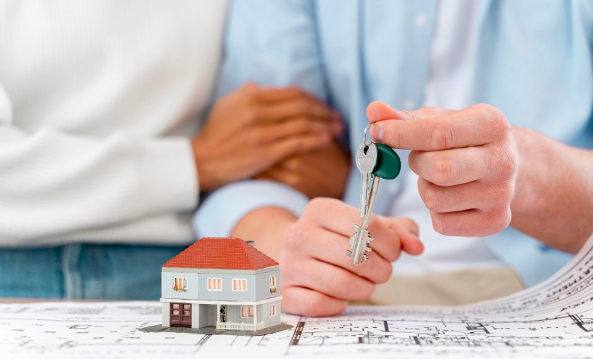 Couple holding keys for their rental