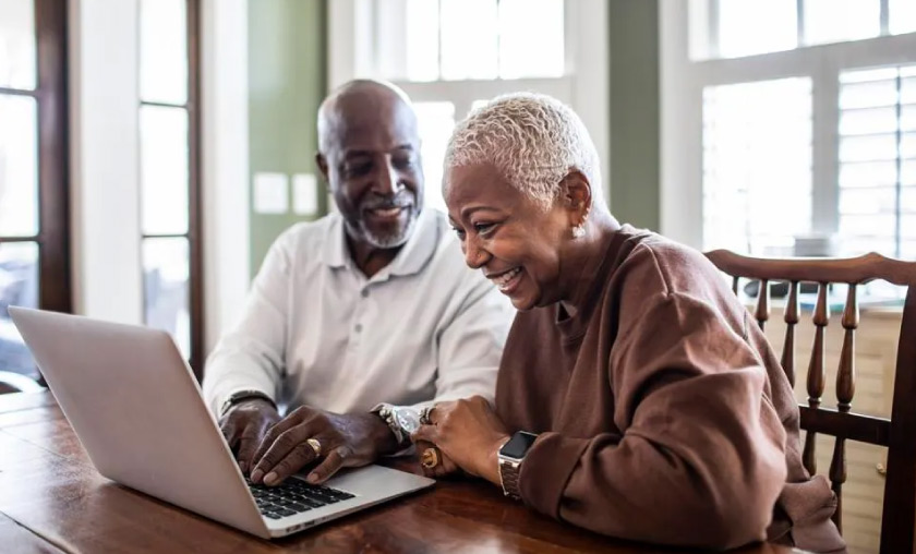 Man and woman looking at computer planning life insurance